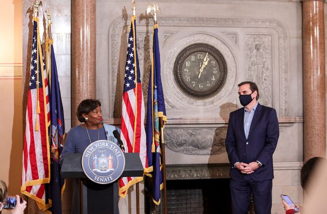 State Senate Majority Leader Andrea Stewart-Cousins stands at a podium announcing Democrats' new supermajority, while deputy leader Mike Gianaris stands nearby.
